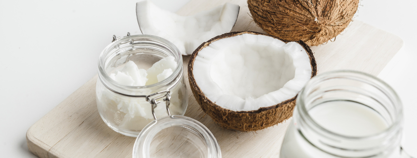 Organic Healthy Coconut Butter And Fresh Coconut Pieces On Woode