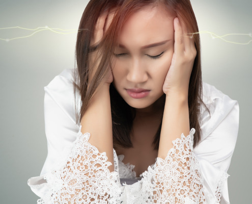 acoustic neuroma treatment - woman suffering headache