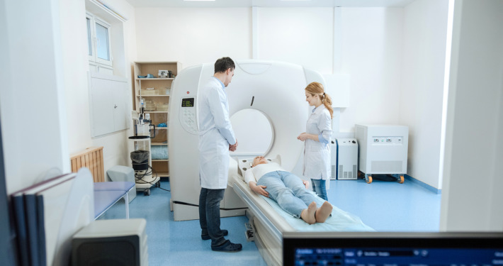 gamma knife surgery - doctors standing over their patient