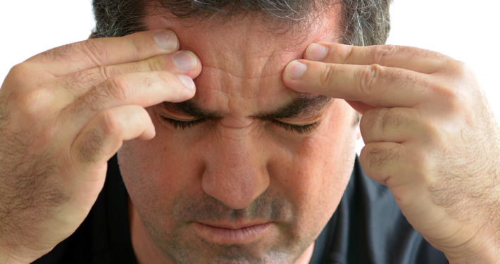 Gamma Knife surgery - Man with headache holding his hands
