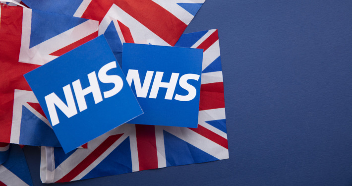 brain tumour treatment - NHS National health service logo on a union jack flag